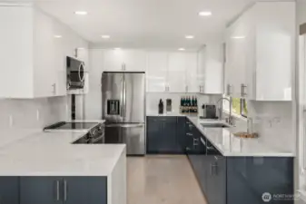 Beautiful kitchen remodel with high-end appliances, quartz countertops and sleek custom cabinets.