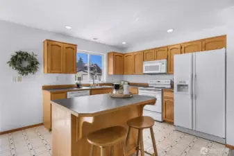 Kitchen has breakfast bar with additional seating