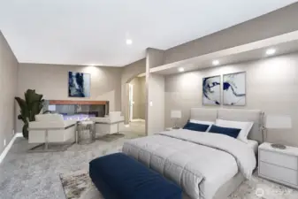 Primary bedroom with electric fireplace.