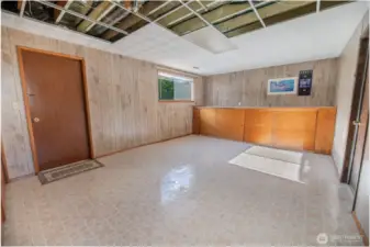 Large bonus or rec room would make a wonderful second kitchen for a ADU or MIL. Door on left is separate entrance. Door on right goes to the attached garage. (Ceiling tiles were removed with new plumbing was recently installed.)