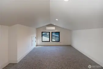 Loft sleeping area has ample space for several beds or one larger bed.