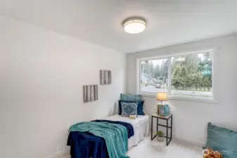 Bedroom#4. This fresh, light-filled bedroom welcomes you with its sunny disposition and airy ambiance. Generous windows invite natural light throughout the day, creating a warm and uplifting retreat.