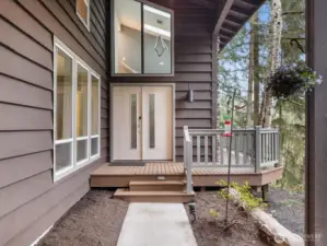 Step into luxury through this stunning double-door entry, where soaring ceilings and windows flood the space with natural light.