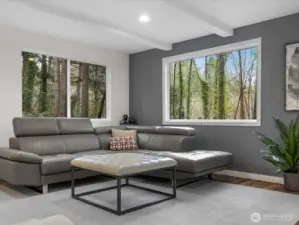 Immerse yourself in nature through expansive picture windows that frame the lush, private greenery like living art. This corner offers the perfect tranquil escape, blending modern design with a peaceful wooded backdrop.
