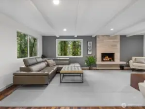From the perspective of the reading area you are treated to a full view of the home's modern architectural character highlighted by the striking beam ceilings and designer Travertine fireplace.