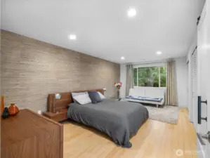Experience this spacious masterfully designed primary suite featuring recess lighting, textured wall, sustainable bamboo floors, large double closet, with new doors and an elegant new door leading to the updated private en-suite.