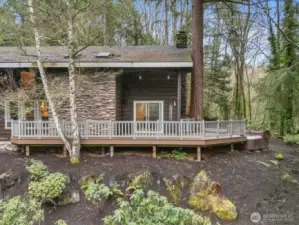 Embrace the ultimate in private luxury with this architectural masterpiece, where striking textured siding an expansive wraparound deck offer a seamless indoor/outdoor lifestyle nestled within a serene forest setting.