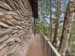 Immerse yourself in a secluded forest oasis, where dramatic custom-stone facade and tranquil forest guide you effortlessly from the main entrance to your secluded entertainment patio.