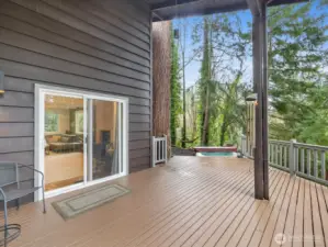 Set in a rare, park-like setting with peaceful natural views, offering a sense of privacy and tranquility rarely found in the city. Nestled in a secluded oasis, where the only sounds are birdsong and rustling evergreens.    • Expansive wrap-around deck overlooking Carkeek Park, freshly painted and power-washed in 2026—perfect for entertaining or relaxing in nature on your private Jacuzzi, seen here at the back end of the patio.