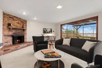 A wall of glass windows in lower rec room provides an abundance of natural light, and offers tree filtered views