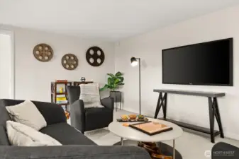 This spacious lower-level recreation room is ideal for a large TV or projection screen, making it perfect for movie nights