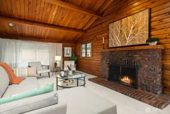 Substantial brick fireplace with hand carved wood mantel radiates warmth and earthiness