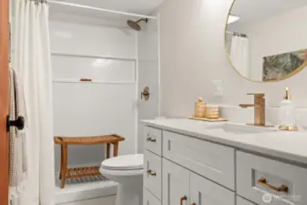 Completely remodeled main floor bath with walk-in shower, large vanity and tiled flooring