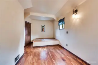 Main floor bedroom with en-suite.  The built-in platform bed allows a queen sized mattress and features hidden storage in its base