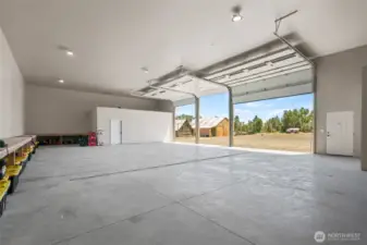 3 Bay rollup doors on shop with drain in floor.