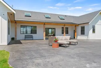 Large patio with 3 points of entry from house and view of the arena