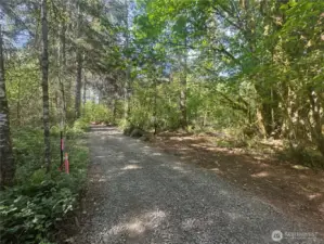 New driveway running through property to building site at back.