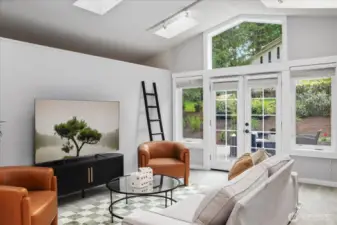 This spacious room has french doors that open to a side yard. This home has so many spaces to not only enjoy the outdoor views, but to also enable bringing the outdoors, in.