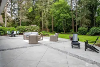 Spacious backyard with stamped concrete and stone pavers add architectural intrigue great to create multiple outdoor spaces.