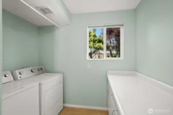 Bright laundry area with built-in work/folding area