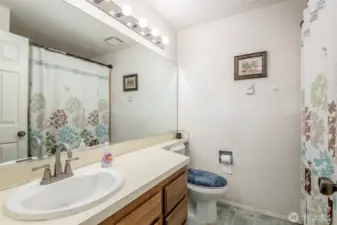 Full bath in hallway with soaking tub.