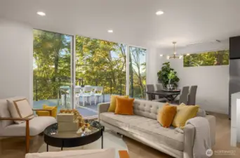 This living area offers modern serenity with panoramic glimpses of greenery, setting the perfect backdrop for both relaxation and entertaining.