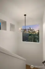 Transitional spaces in this home are anything but ordinary—architectural hallways accented by modern sconces and large picture windows create gallery-like moments between rooms.