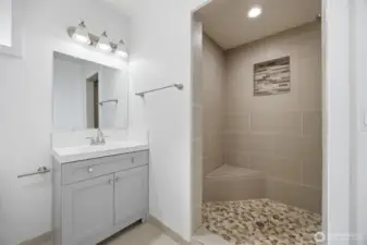 Guest bath w nice sit down tiled shower.