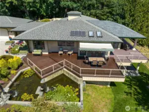 This huge entertaining deck wraps around the front and has a gas heater hook up for overhead heating.  That's a Sunsetter electric Awning and a Sunroom too!