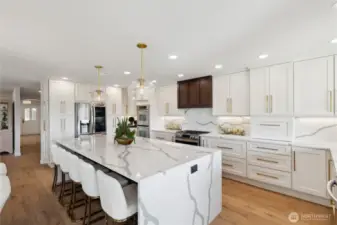 That is a solid slab of Granite with waterfall edges and look at the matching back splash. Those custom drawers and cabinets are all new. Those Bar Stools at the Island stay with the home.  There are storage cabinets under the Island where the stools are.