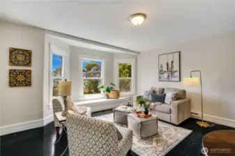 This inviting one-bedroom, one-bathroom upstairs unit features a delightful window seat in the bay window, providing the perfect spot to unwind. Beautiful hardwood floors and fresh paint enhance the timeless appeal of this comfortable living space.