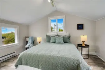 With new flooring, fresh paint, and three sun-filled windows, this bedroom offers a warm and welcoming atmosphere.
