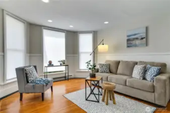 Bathed in natural light from three sun-filled windows, this spacious living room offers a warm and welcoming ambiance. Charming beadboard details and recessed lighting create a perfect blend of old and new, while fresh paint throughout ensures a move-in-ready experience.