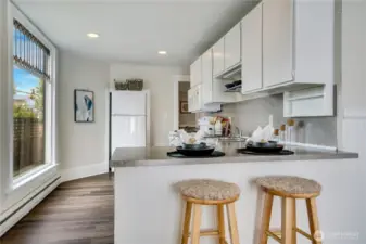 Designed for effortless entertaining and everyday convenience, this open floor plan seamlessly connects the eat-in kitchen to the living spaces.