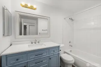 The guest bathroom features a sleek, updated vanity—offering a fresh, clean look.