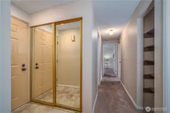 Step inside to a welcoming entryway with a large coat closet, plush carpet, and calming tones throughout.