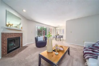 The living room flows seamlessly into the dining area, enhanced by beautiful natural light.