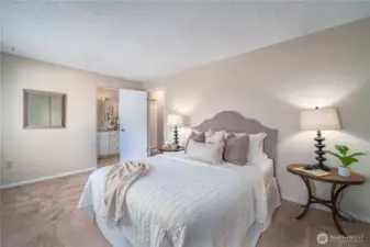 The serene primary bedroom offers comfort and quiet at the end of your day.