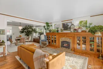 Original hardwood floors and trim flow throughout open living space