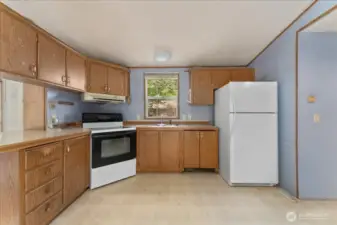 Kitchen incudes the refrigerator and stove.