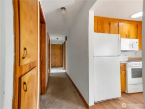 The hallway has built-in cabinets for storage