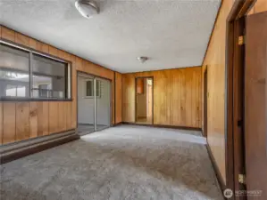 Sliding glass doors take you from the rec room or hallway out to the enclosed patio