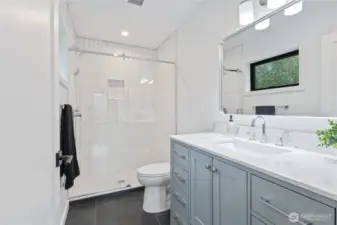 Primary bathroom with tiled shower.