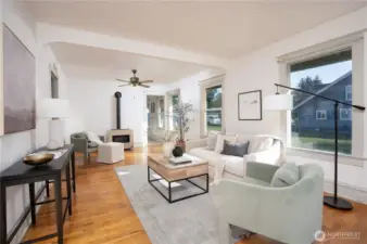 Enter into a bright living space with hardwood flooring, and a floor mounted gas hearth- perfect for getting cozy in the cooler months!