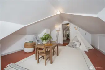 The upstairs offers additional versatile space, perfect for a guest room, home office, or cozy hangout area.