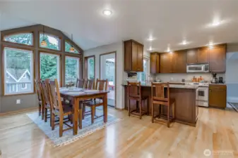 Expanded breakfast nook with wall of windows to enjoy the view of the park-like yard