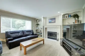 The family room features a fireplace flanked by bookshelves.