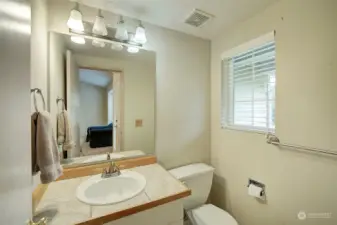 A powder room bath is featured just off the foyer.