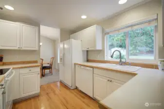 White cabinets and countertops create a light and bright kitchen.