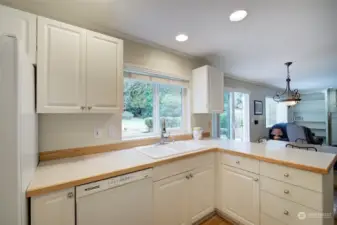 A peninsula with barstool seating adjoins the kitchen and breakfast nook